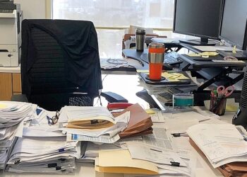 person at messy desk xfv 1456w 3123 6449 1764577868.jpg