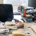 person at messy desk xfv 1456w 3123 6449 1764577868.jpg